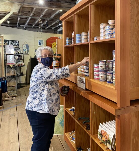 Volunteer stocking shelves in Gulf of Georgia Cannery gift shop