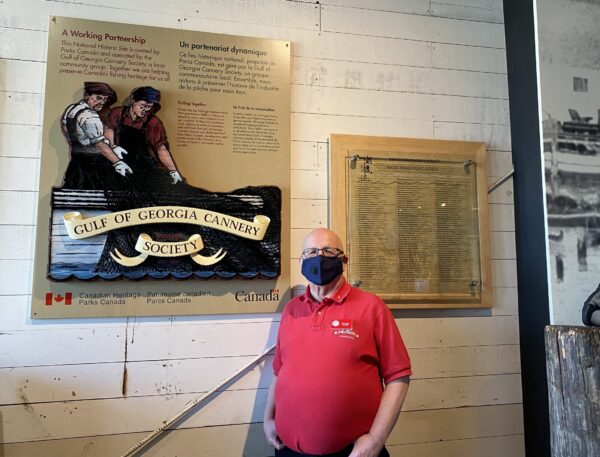 Gulf of Georgia Cannery volunteer posing in front lobby